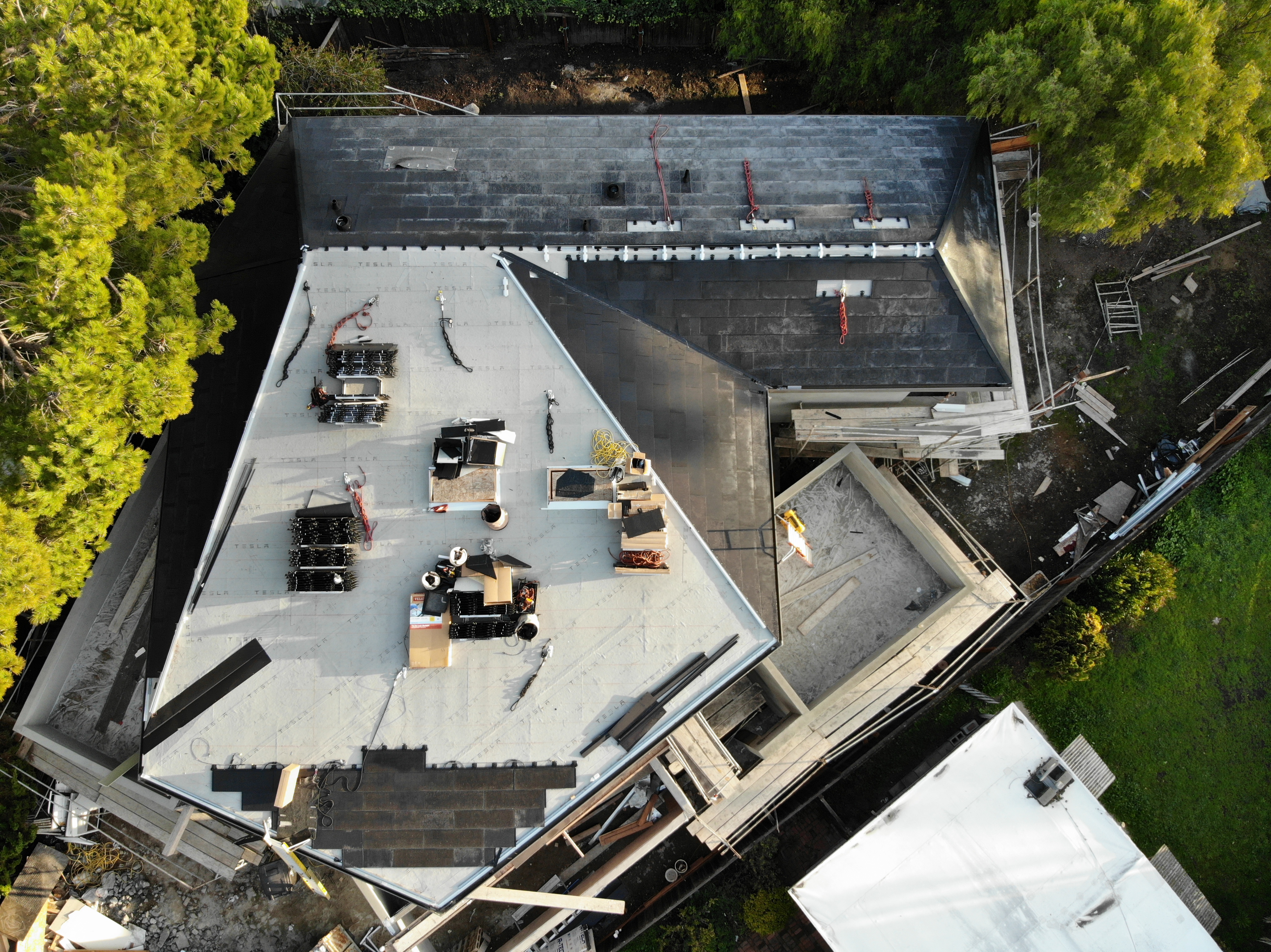 Aerial drone view — Tesla Solar Roof installation in progress